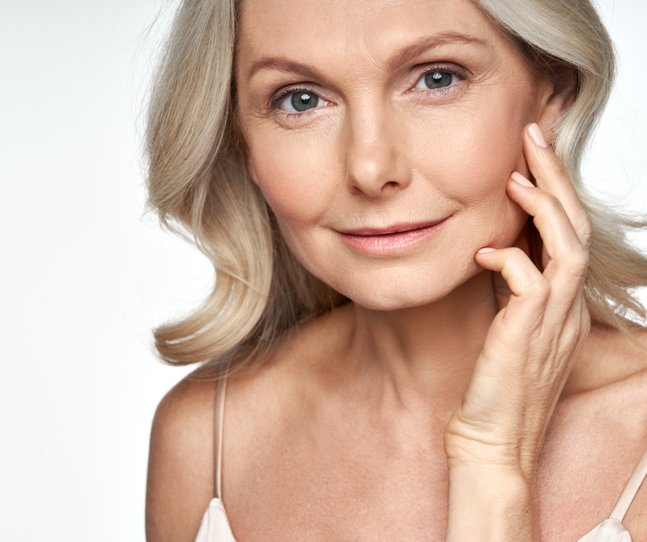 Dermal Fillers An older woman admiring her face after a Dermal Filler.